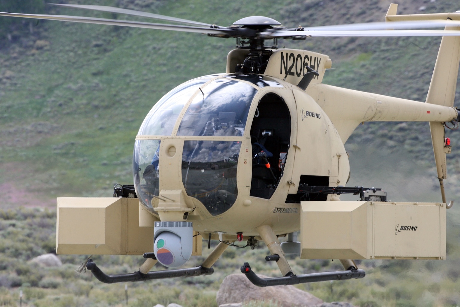 US Navy 090616-M-9917S-144 The Unmanned Little Bird (ULB)
	         helicopter, a smaller variant of the larger, manned A-MH-6M can
	         be controlled by a pilot or piloted remotely